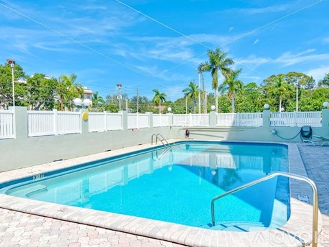 A rectangular pool with a metal ladder on the side.