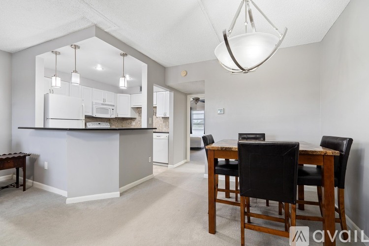 A kitchen with a dining table and chairs.