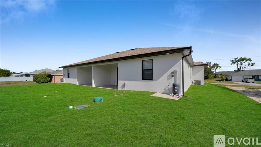 A house with a white exterior and a brown roof is for sale.