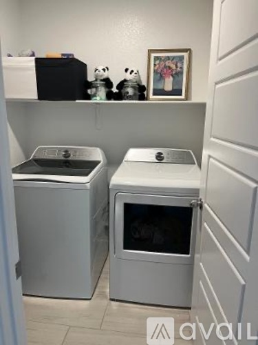 A small kitchen with a dishwasher and a washing machine.