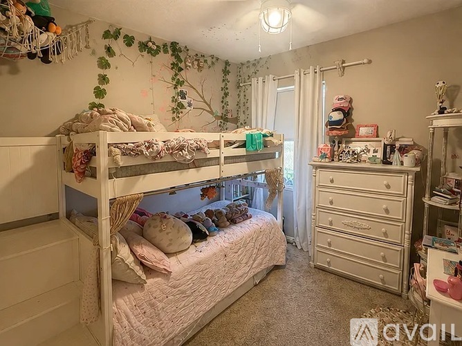 A bedroom with a bunk bed and a dresser.