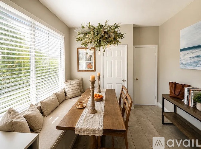 A dining room with a wooden table and chairs.