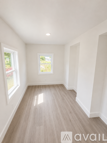 A bedroom with a bed, nightstands, and a ceiling fan.
