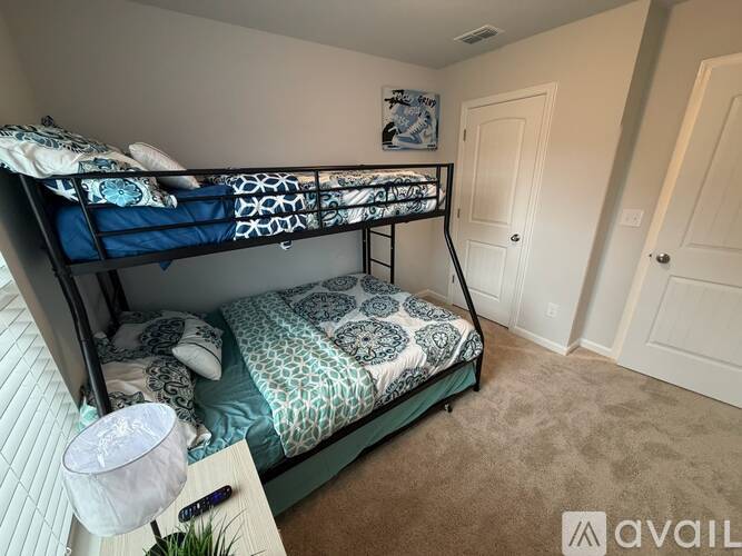 A bedroom with a bunk bed and a single bed.