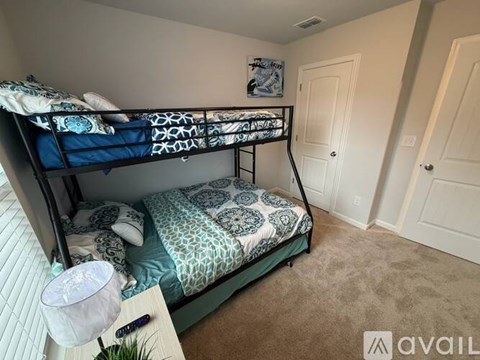 A bedroom with a bunk bed and a single bed.