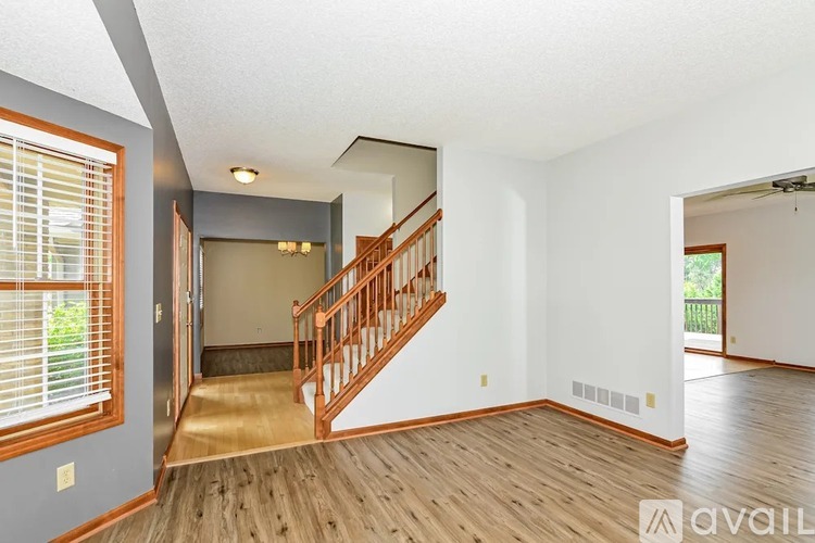 A room with wooden flooring and a sign that says "TEXT OR CALL 916-620-5420".