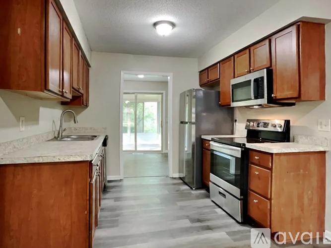 A kitchen with wooden cabinets and stainless steel appliances.