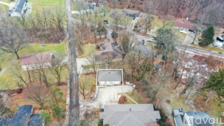A bird's eye view of a residential area with houses and trees.