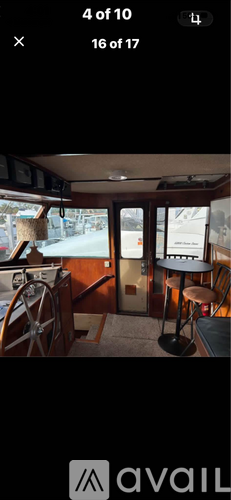 A boat interior with a steering wheel and a navigation screen.