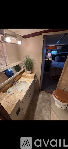 A bathroom with a toilet, sink, and mirror.