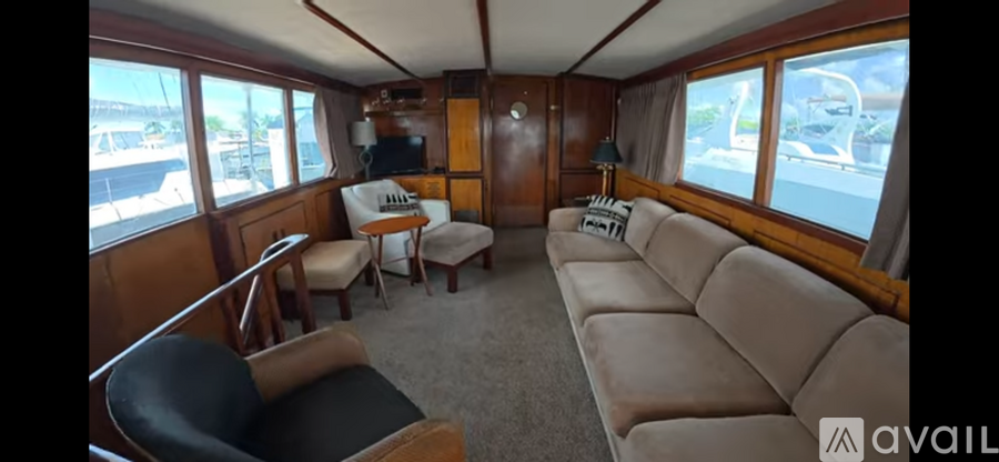 A living room with a couch, chairs and a television.