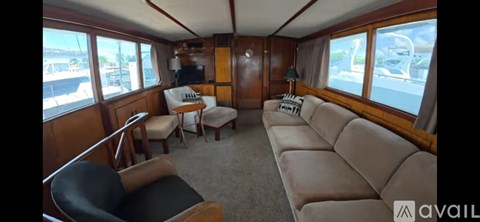 A living room with a couch, chairs and a television.