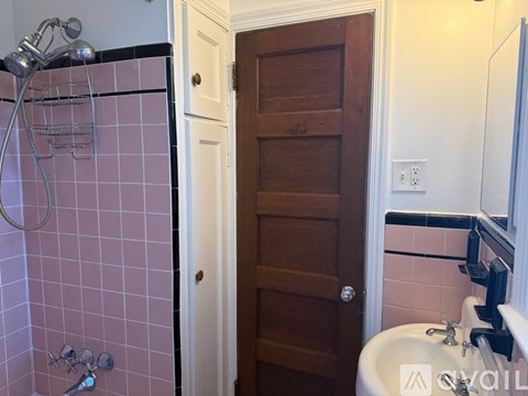A hallway with a carpeted floor and a door on the right.