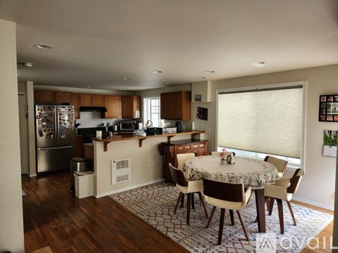 A kitchen with a table and chairs in the middle of the room.