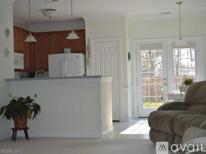 A kitchen with brown cabinets and a white refrigerator.