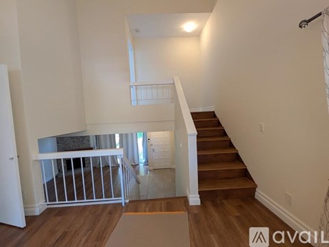 A living room with a white couch and a television.