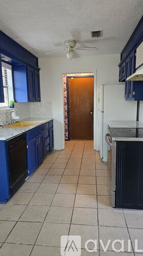 A kitchen with blue cabinets and a white ceiling.