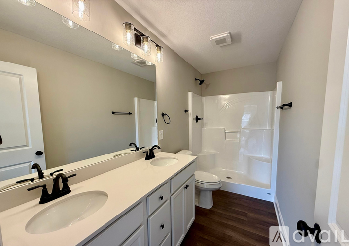 A bathroom with a white sink and a white toilet.