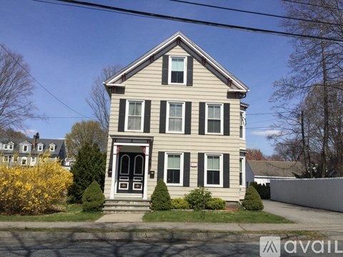 A two-story house with a front porch and a small front yard.