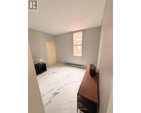 A room with a marble floor and a window.