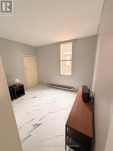 A room with a marble floor and a window.