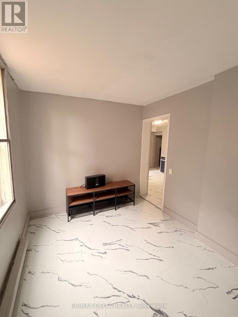 A room with a bench and a laptop on it.