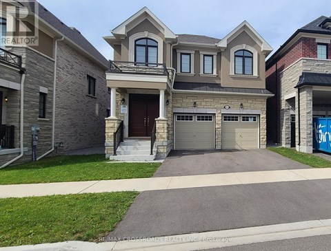 A large, two-story house with a garage is for sale.