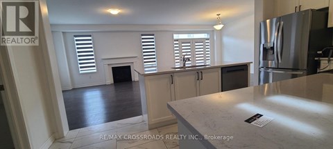 A kitchen with a refrigerator and a counter top.