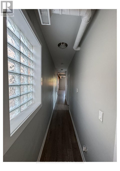 A long hallway with a row of windows on the left side.