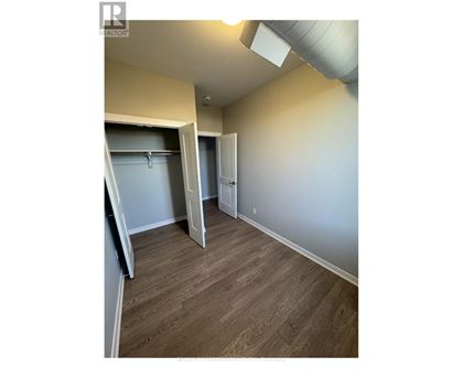 A room with a sliding door and a closet.