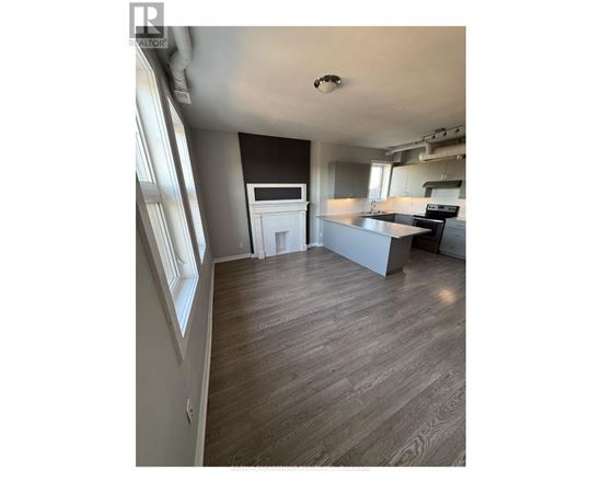 A kitchen with a counter and a fridge.