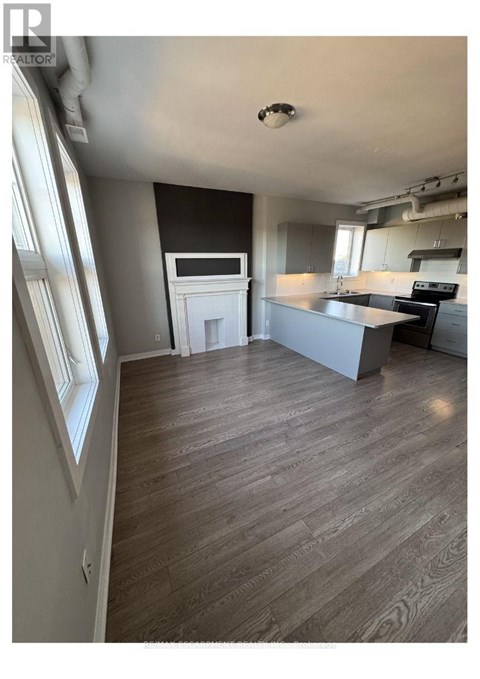 A kitchen with a counter and a fridge.