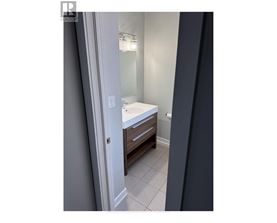 A bathroom with a white sink and a mirror.