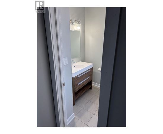 A bathroom with a white sink and a mirror.