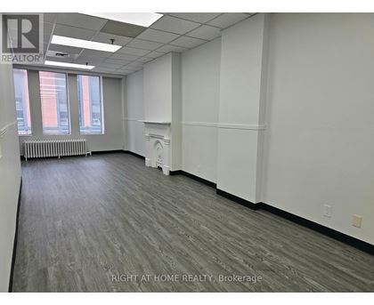 A room with a grey floor and white walls.