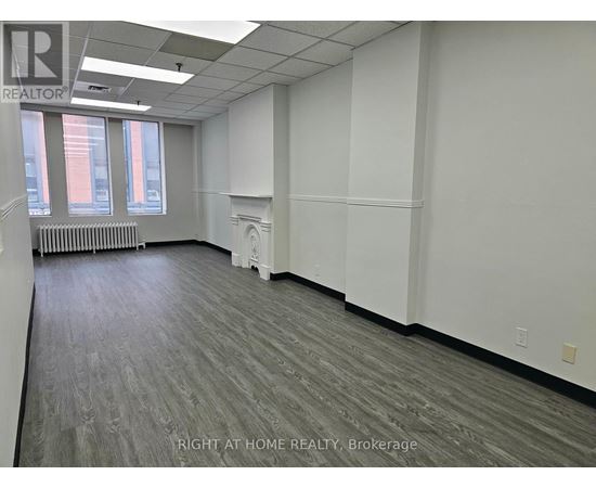 A room with a grey floor and white walls.