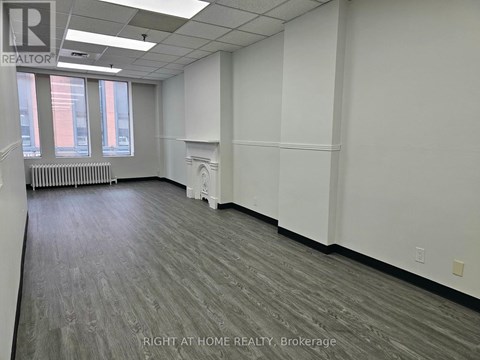 A room with a grey floor and white walls.