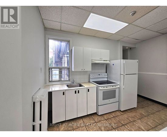 A kitchen with white appliances and cabinets is shown.