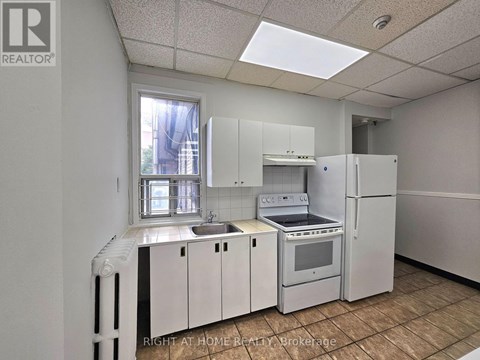 A kitchen with white appliances and cabinets is shown.