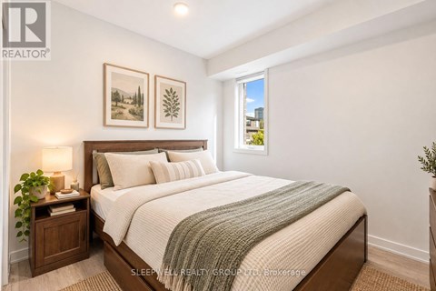 A bedroom with a large bed and a window.
