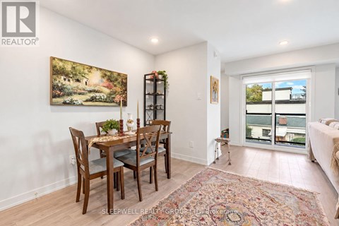 A dining room with a table set for four.