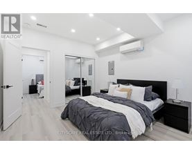 A bedroom with a large bed and a mirrored closet door.