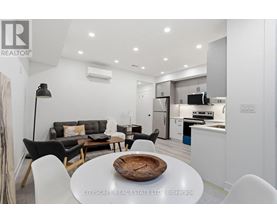 A modern kitchen with a dining table set in the middle.