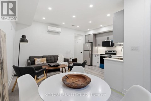 A modern kitchen with a dining table set in the middle.