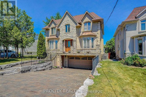 A large, two-story house with a stone facade and a garage is for sale.