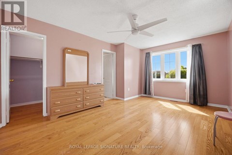A bedroom with a dresser and a window with curtains.