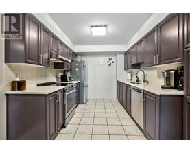 A kitchen with dark brown cabinets and a white counter top.