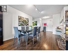 A dining room with a table set for four.
