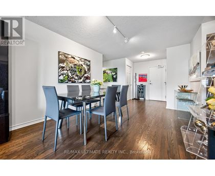 A dining room with a table set for four.
