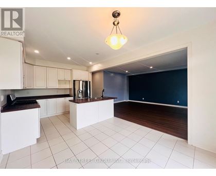 A kitchen with white cabinets and a dark countertop.